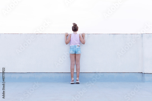 Teenage girl on her back with white background. Social problems concept.