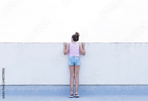 Teenage girl on her back with white background. Social problems concept.