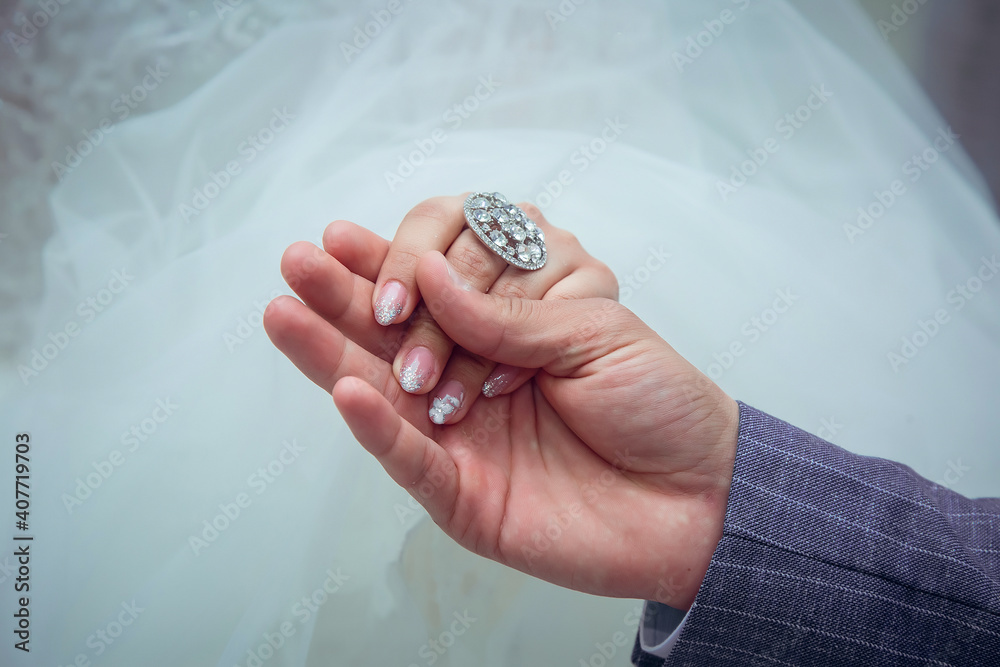 the guy holds the hand of his bride