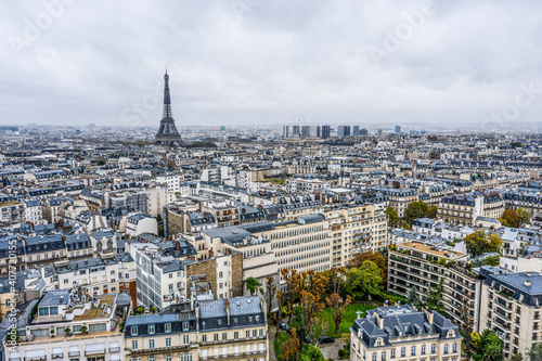 View on Eiffel tower over the roofs of Paris on a grey cloudy day