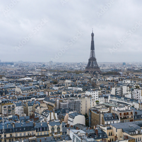 View on Eiffel tower over the roofs of Paris on a grey cloudy da