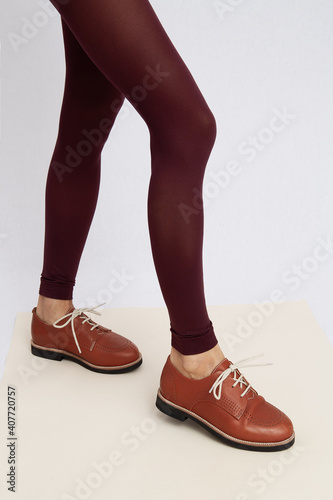 Shoot of unrecognizable woman wearing retro look. Vintage brown shoes and leggins. Fashion vintage shop concept
