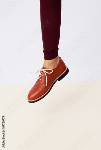 Shoot of unrecognizable woman leg wearing retro vintage brown shoes and leggins. Fashion vintage shop concept