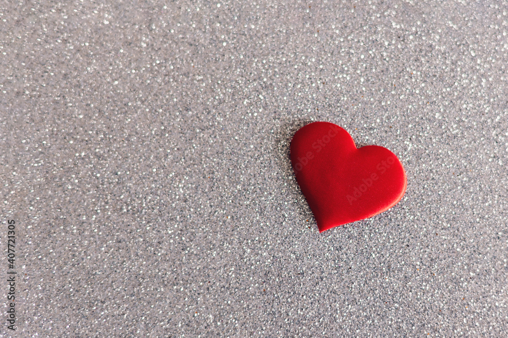 Red heart on a grey sparkle background. Minimal concept for Valentine day. Red heart on a grey sparkle background. Minimal concept for Valentine day.