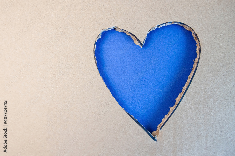 Blue heart shape cut from cardboard. Concept of Saint Valentines day Blue heart shape cut from cardboard. Concept of Saint Valentines day