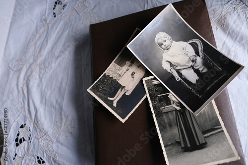 old photo albums lie on a white mint tablecloth, vintage photographs of 1960, concept of family tree, genealogy, childhood memories, connection with ancestors