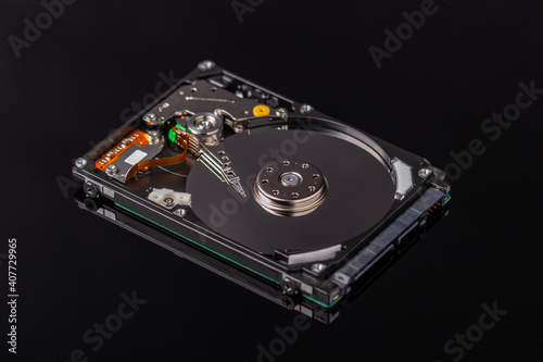 close-up of an open laptop hard drive on black mirror background