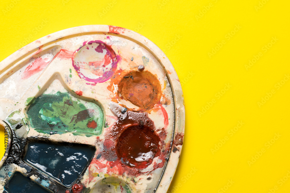 dirty palette on a yellow background. place for text. children's creativity. dirty palette on a yellow background. place for text. children's creativity.