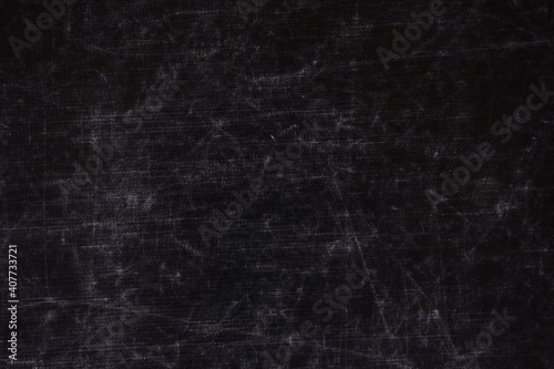 The texture of scratches on fabric on a black background, the texture of a silver reflector in the light