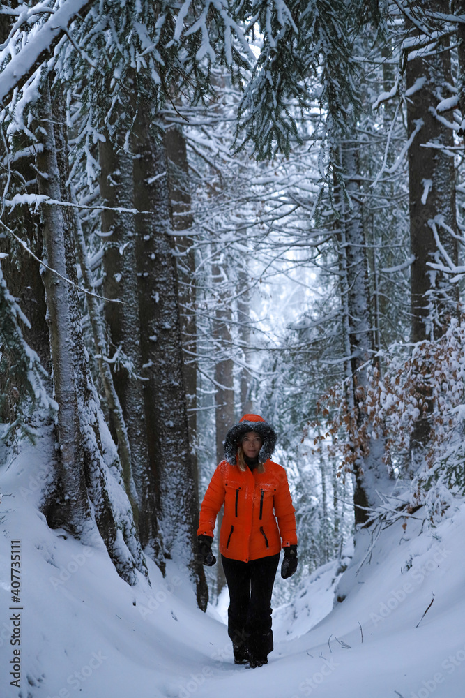 Woman hiking in forest during winter