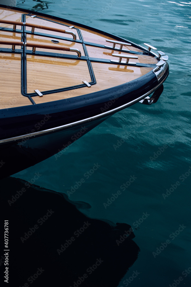 The front of a wooden yacht against the blue sea