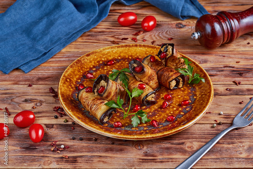 Eggplant with nut filling, Georgian cuisine, wooden background photo