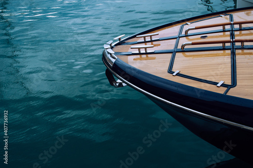 The front of a wooden yacht against the blue sea © Yevhenii