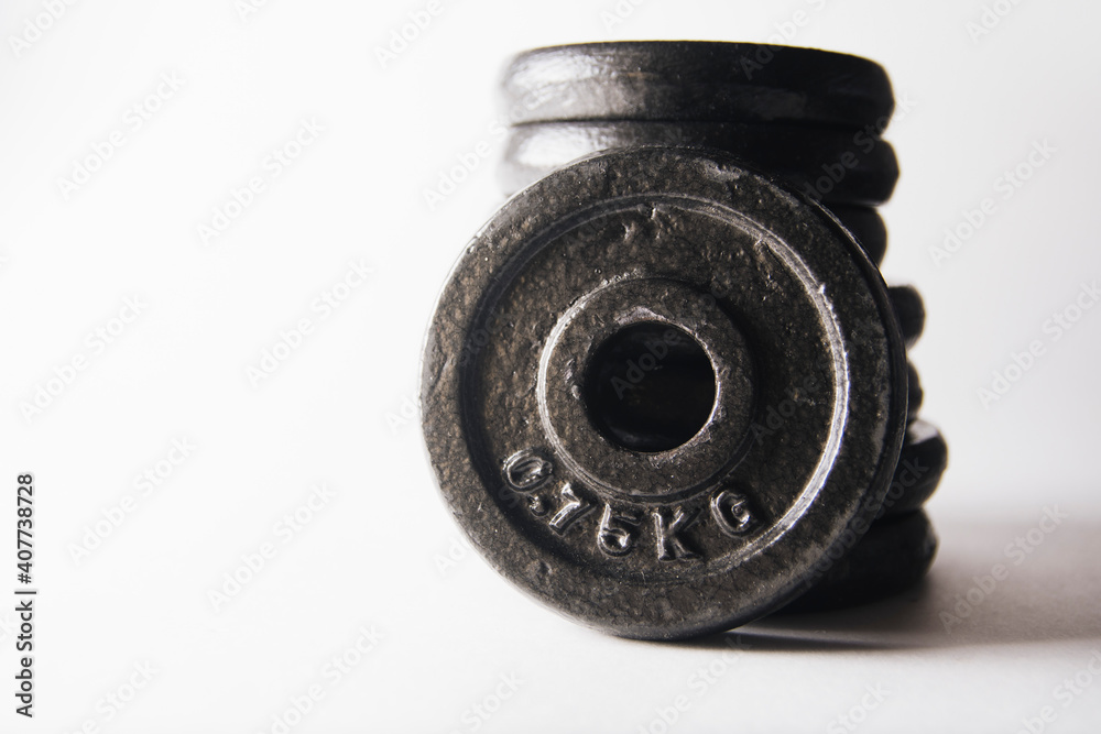 additional weights for dumbbells on a white background additional weights for dumbbells on a white background