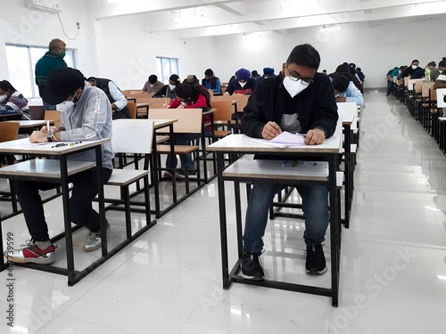 December 8, 2020.Lucknow Uttar Pradesh,India. West Bengal India. Medical students writing examination paper in mask maintaining social distancing at Radheshwam Medical College,Lucknow, UP, India