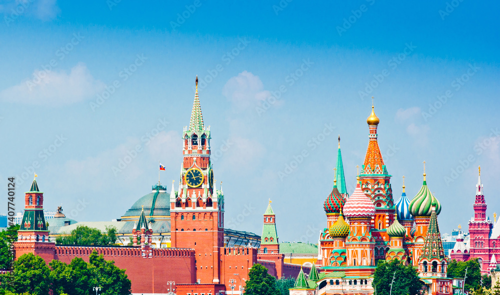 Spasskaya Tower of Moscow Kremlin and the Cathedral of Vasily the Blessed (Saint Basil's Cathedral) on Red Square. Sunny summer day. Moscow. Russia Spasskaya Tower of Moscow Kremlin and the Cathedral of Vasily the Blessed (Saint Basil's Cathedral) on Red Square. Sunny summer day. Moscow. Russia