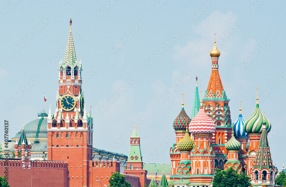 Spasskaya Tower of Moscow Kremlin and the Cathedral of Vasily the Blessed (Saint Basil's Cathedral). Red Square. Summer sunny day. Moscow. Russia Spasskaya Tower of Moscow Kremlin and the Cathedral of Vasily the Blessed (Saint Basil's Cathedral). Red Square. Summer sunny day. Moscow. Russia