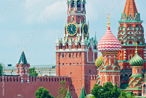 Spasskaya Tower of Moscow Kremlin and domes of the Cathedral of Vasily the Blessed (Saint Basil's Cathedral) on Red Square. Close-up. Moscow. Russia
