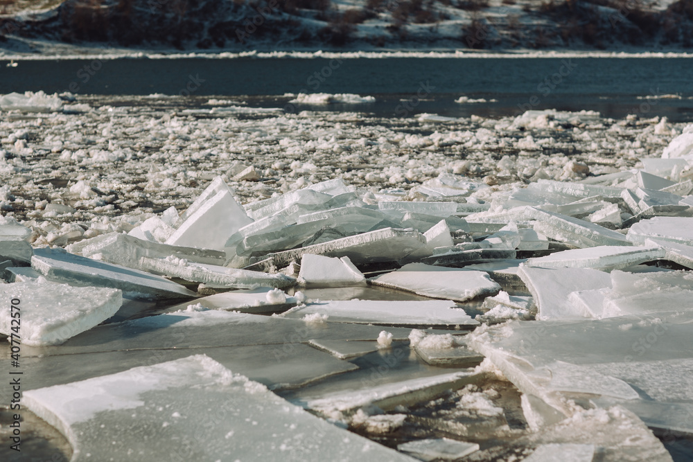 Thick ice pieces on the river in the winter thaw.
