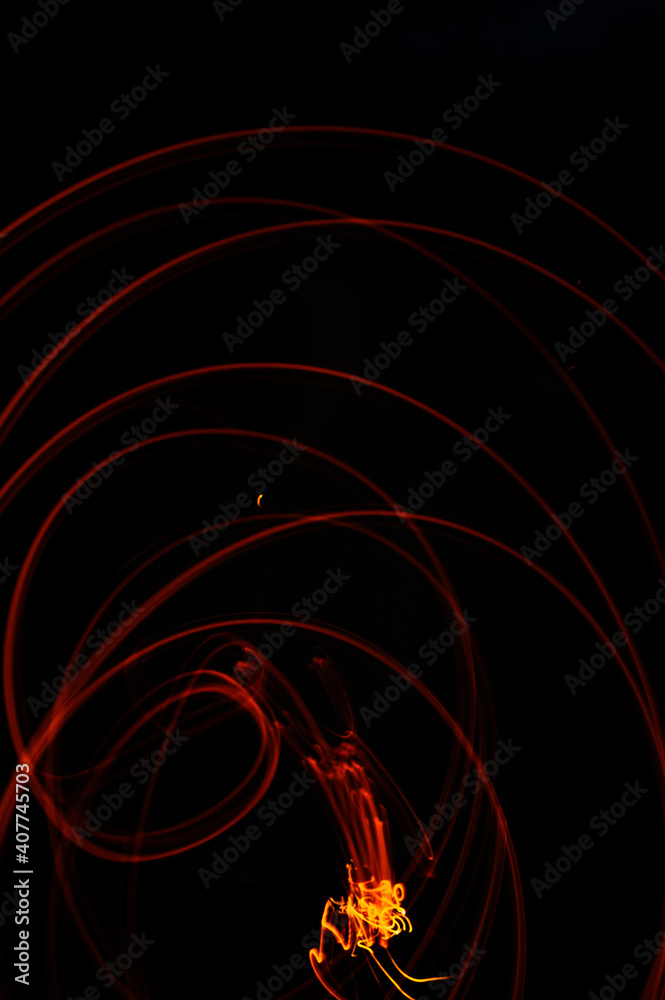 burning fire emitting sparks and embers, drawing wild energetic patterns of light, the artist's imagination with fire. burning fire emitting sparks and embers, drawing wild energetic patterns of light, the artist's imagination with fire.