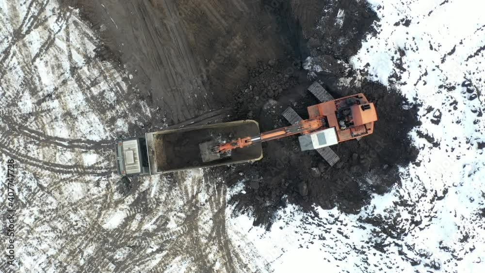 Aerial top view on crawler excavator digging ground for overhaul road. Construction machinery performs energy intensive heavy work on project Aerial top view on crawler excavator digging ground for overhaul road. Construction machinery performs energy intensive heavy work on project