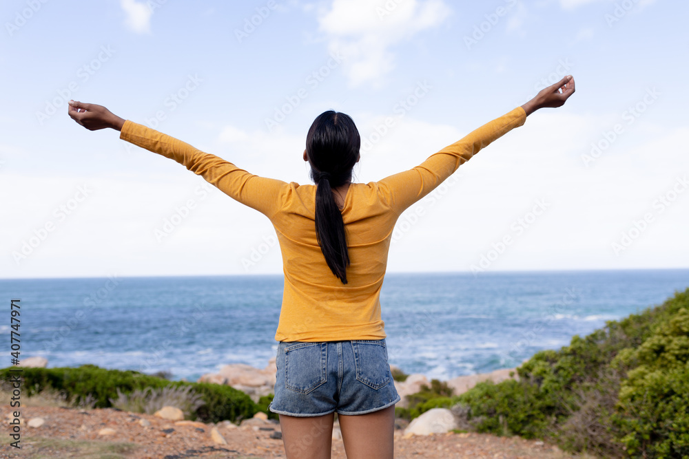 Fit african american woman standing spreading arms in mountain countryside Fit african american woman standing spreading arms in mountain countryside