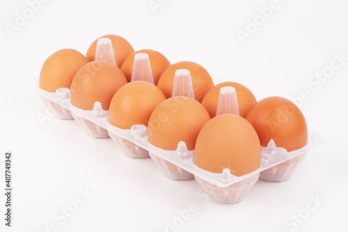 Fresh hen eggs in egg tray box on the white background