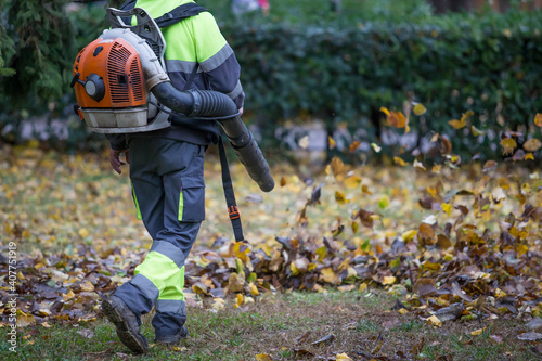 Gardener working with leaf blower.
