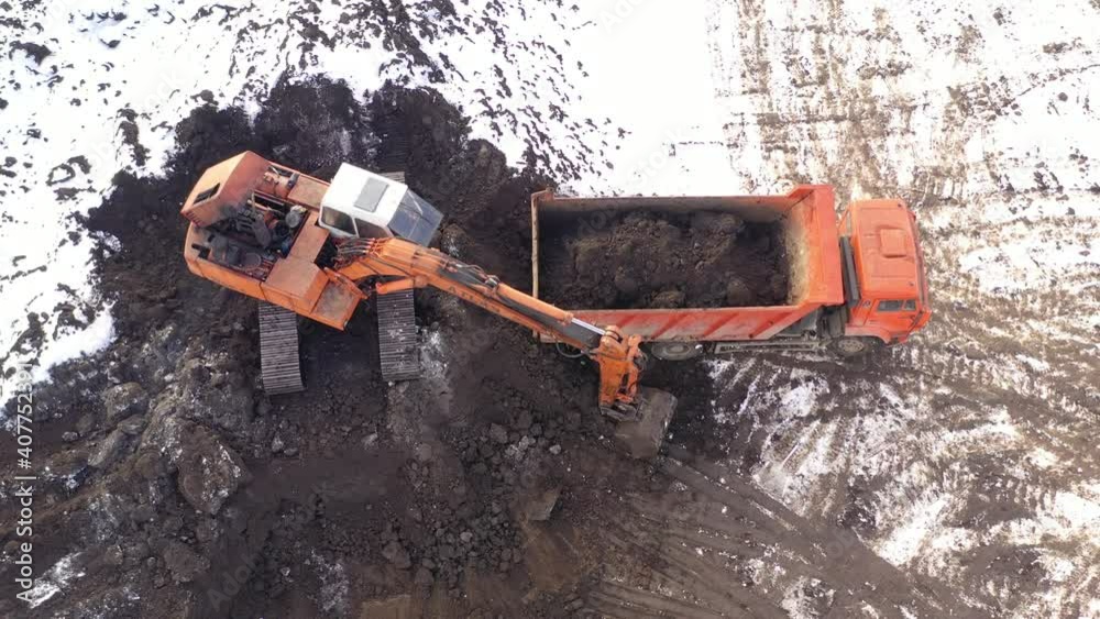 Aerial top view on crawler excavator digging ground for overhaul road. Construction machinery performs energy intensive heavy work on project Aerial top view on crawler excavator digging ground for overhaul road. Construction machinery performs energy intensive heavy work on project