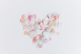 Happy Valentines day. Colorful confetti in heart shape on white background, flat lay. Love