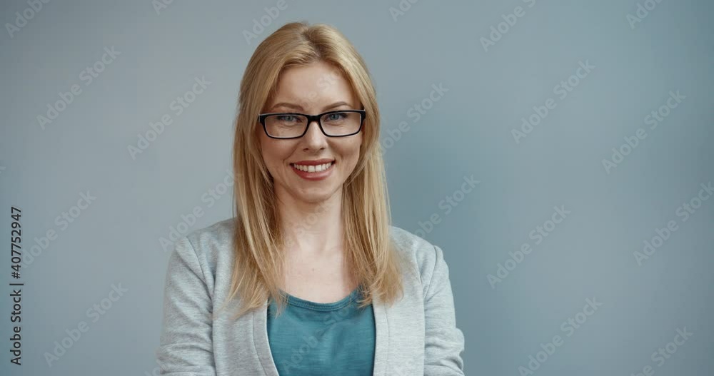 Portrait of smart happy beautiful caucasian woman with blond hair in glasses looking into camera lens smiling. Portrait of smart happy beautiful caucasian woman with blond hair in glasses looking into camera lens smiling.