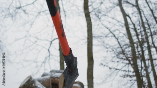 A man chops wood with an ax.