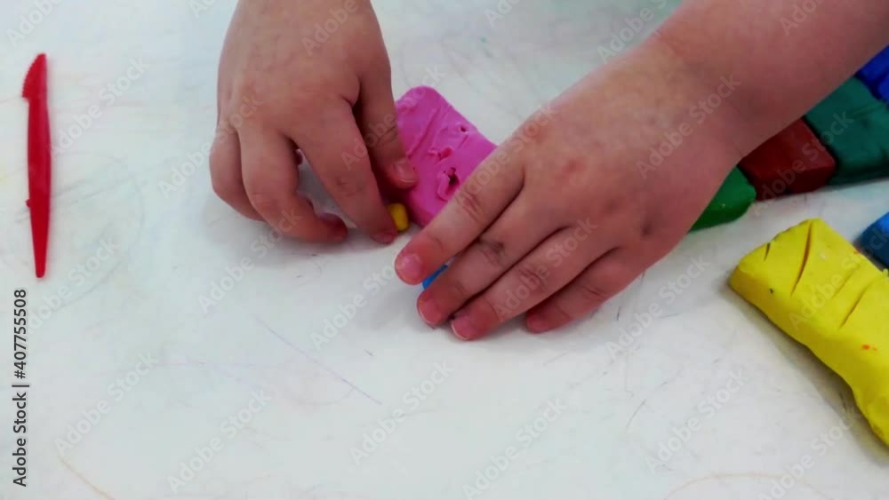 The child learns to sculpt from plasticine. Children's hands and plasticine close-up