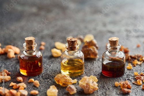Cuadro en lienzo Benzoin, frankincense and myrrh essential oil in bottles, with resin