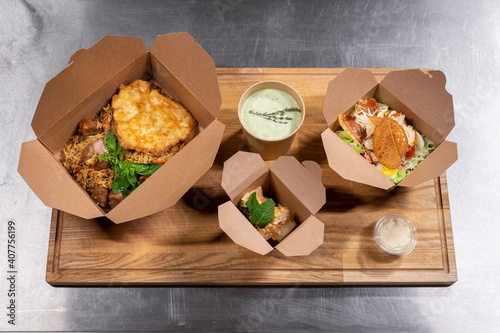 top view of kraft paper food containers with meal for delivery photo