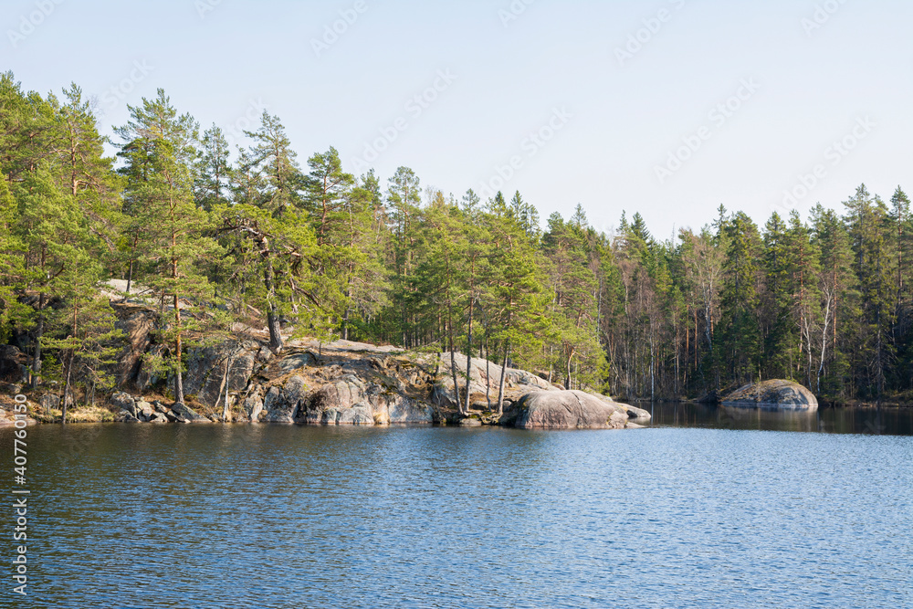 View of Lake Meiko area in spring, rocks, pine trees and lake, Kirkkonummi, Finland View of Lake Meiko area in spring, rocks, pine trees and lake, Kirkkonummi, Finland