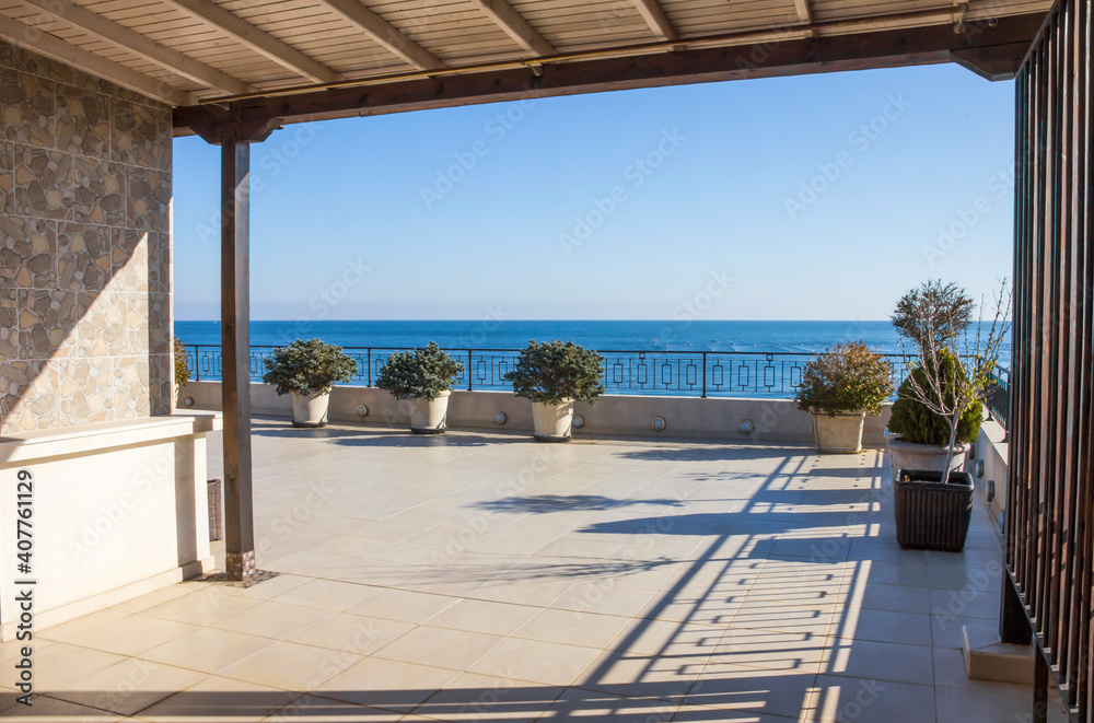 Balcony overlooking the sea. Large modern terrace in a new building on the first line with panoramic sea views. Modern architecture of multi-storey urban development on the seaside.