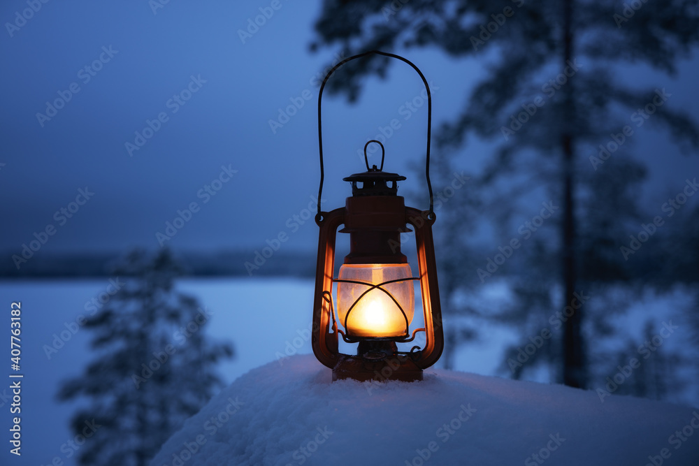 Glowing lantern in winter evening forest. Beautiful winter background. Snow  covered lake and pine trees. Holiday concept. Photos | Adobe Stock