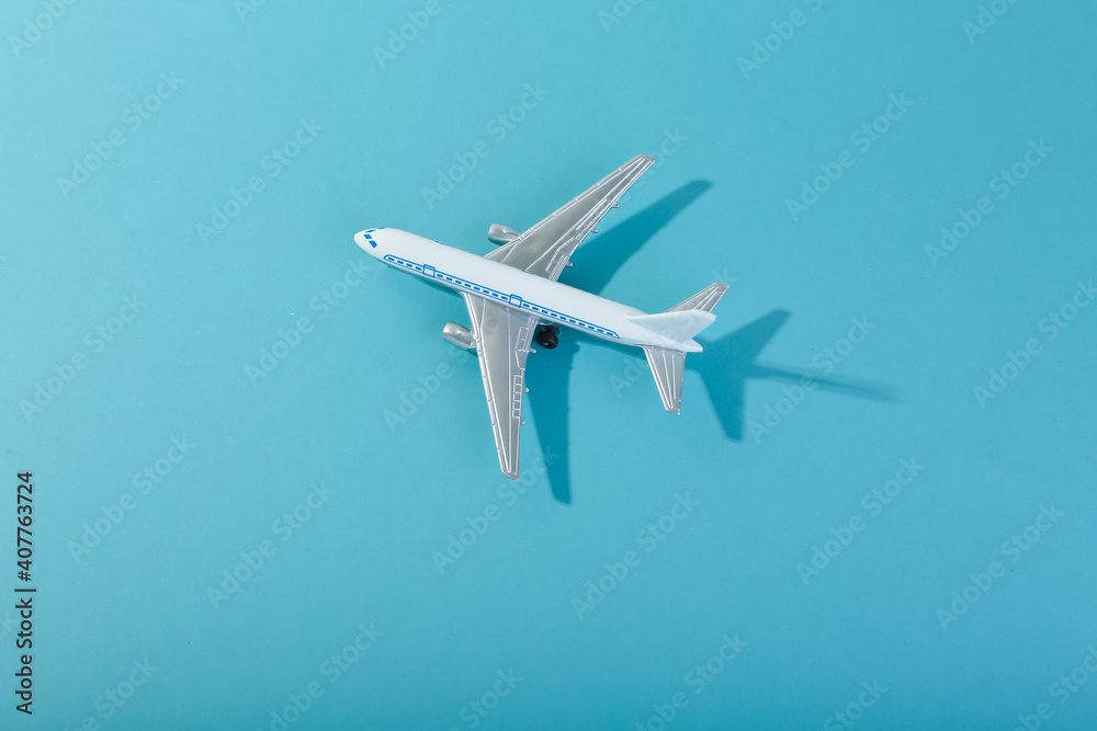 toy airplane on blue background top view with space for text