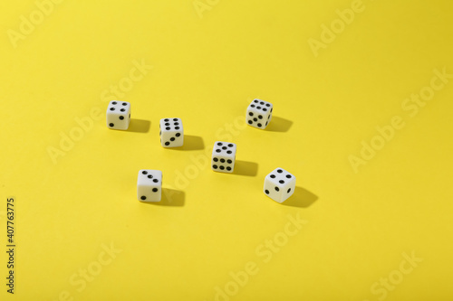 dice on yellow background top view with copy space. 