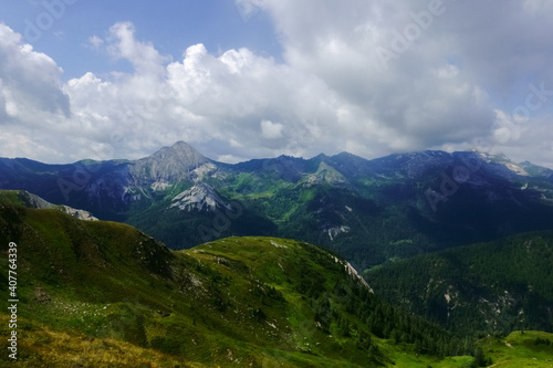 Fototapeta Naklejka Na Ścianę i Meble -  green hills in wonderful mountains with many clouds on the sky