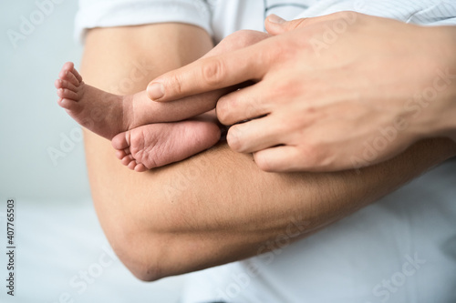 Father holds on arm of the newborn child. High quality photo