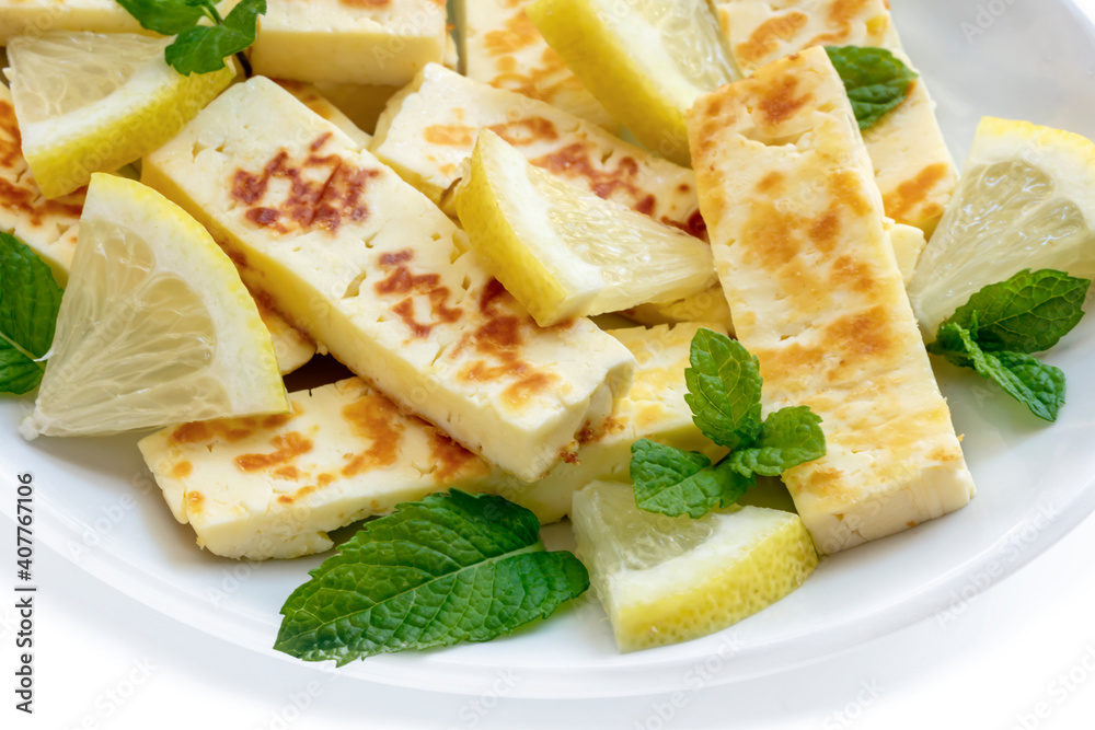 Grilled Halloumi with Lemon and Mint on White Plate Side View