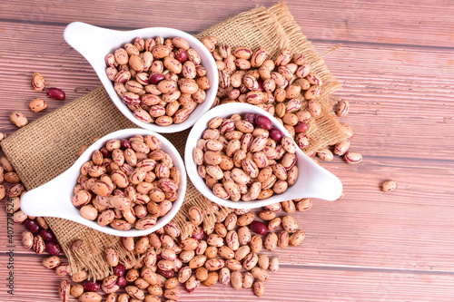 Natural bean grains Phaseolus vulgaris on dark grain wood background