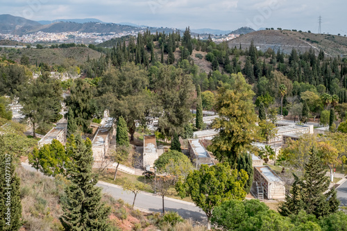 View of the famous Malaga Park Cemetery with graves and crypts, decorated with bouquets of flowers