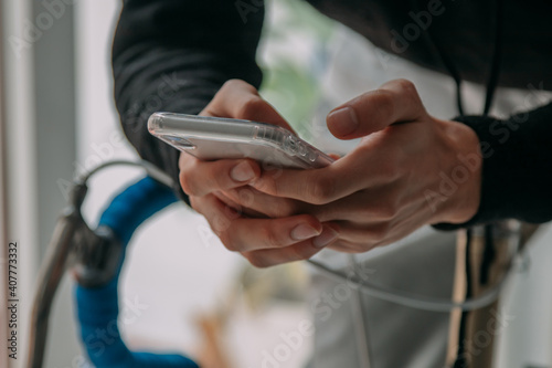 hands with mobile phone on the bicycle photo