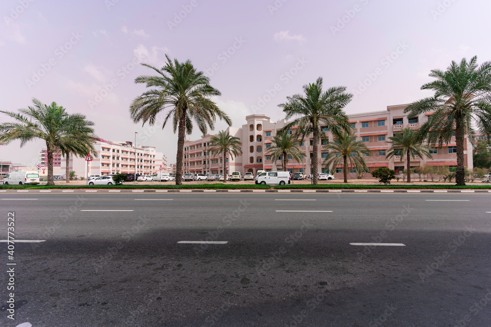 crossroads, a block with beautiful low-rise buildings and palm trees