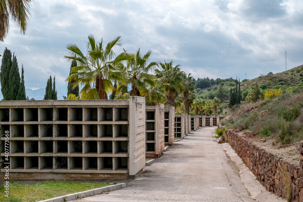 View of the famous Malaga Park Cemetery with graves and crypts, decorated with bouquets of flowers View of the famous Malaga Park Cemetery with graves and crypts, decorated with bouquets of flowers