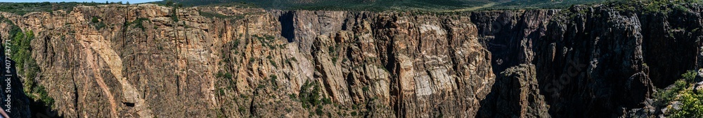 Panorama shot of edge of rocky walls in black canyon of gunnison at sunny day in america