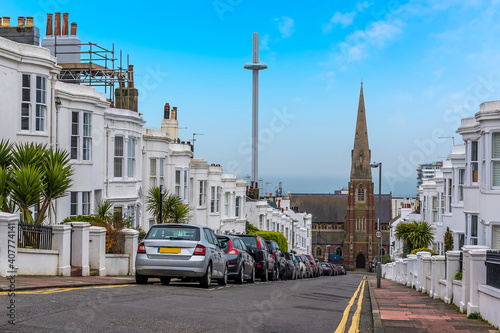 A view down a Georgian street in Brighton with contrasting old and new architecture on a sunny day